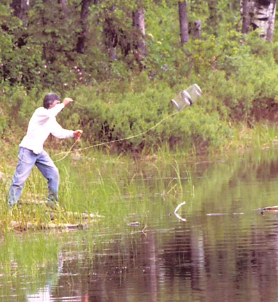 Prof. John Baker demonstrates proper trap-throwing technique, Alaska, 2006. 