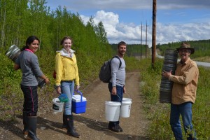 Cynthia, Emma, Ryan, and John carrying traps, buckets, and samples out of Whale Lake